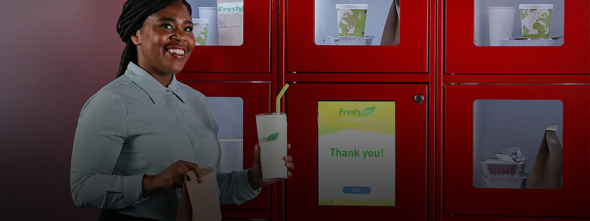 A woman collects food from a Panasonic smart food locker